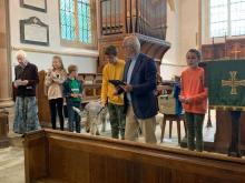 People line up in church with pets